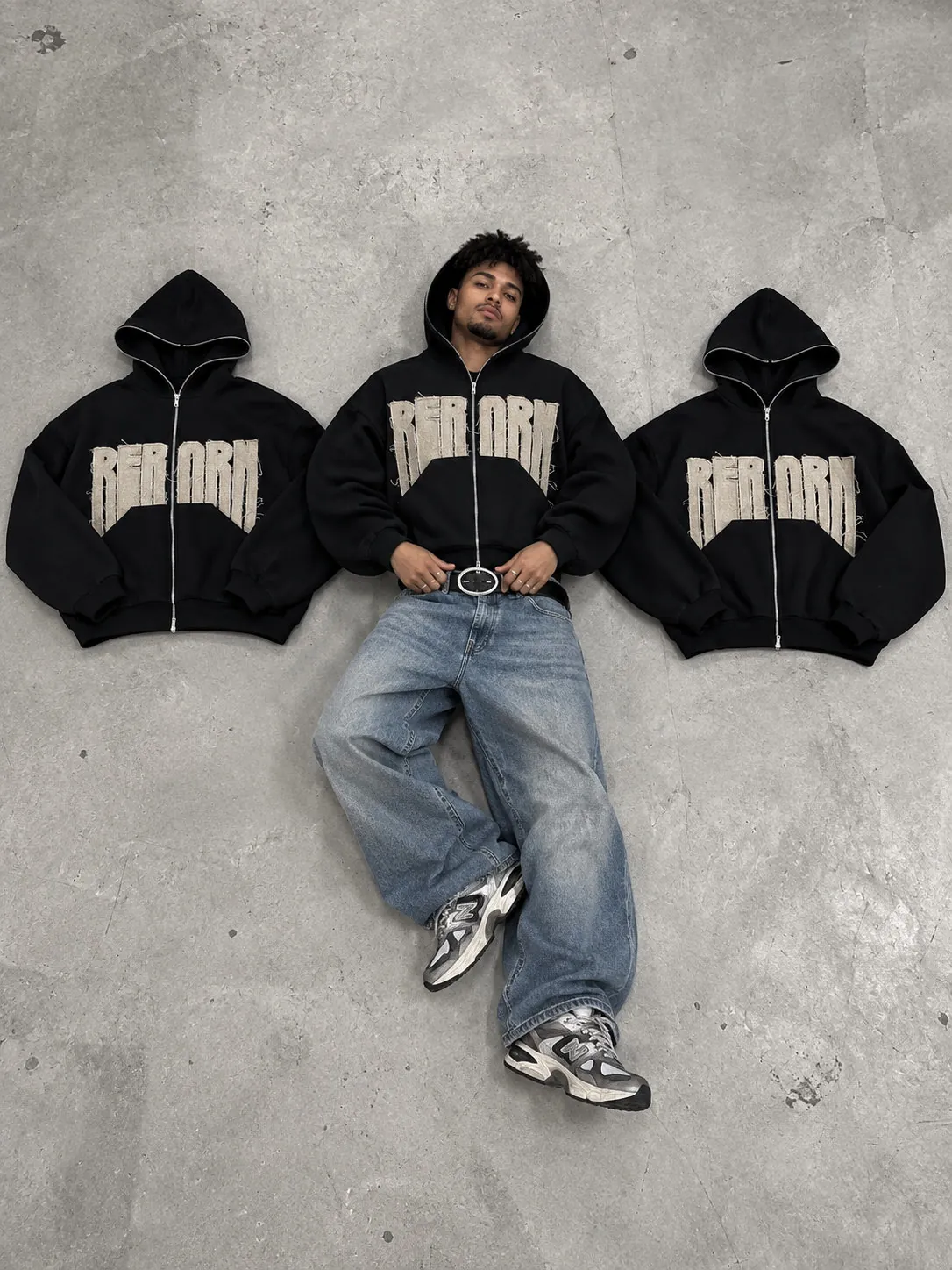 Sudadera REBORN, plano cenital en el suelo